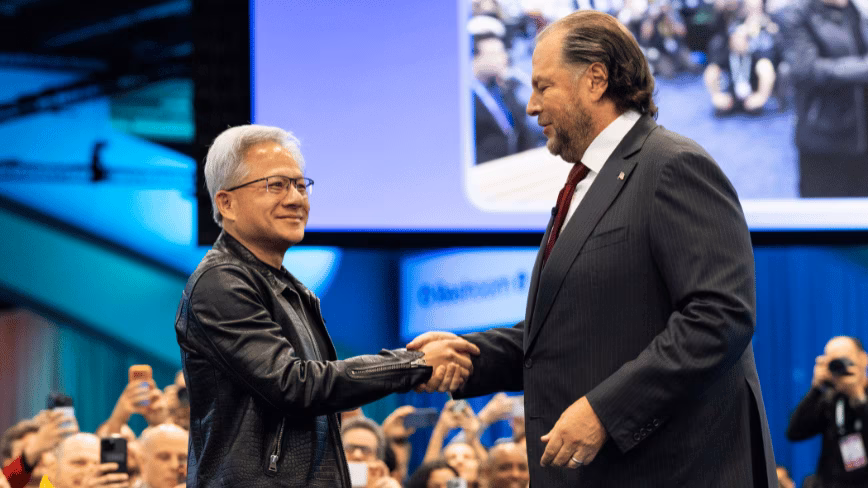 Nvidia’s Jensen Huang and Salesforce’s Marc Benioff shake hands on stage at Dreamforce 2026