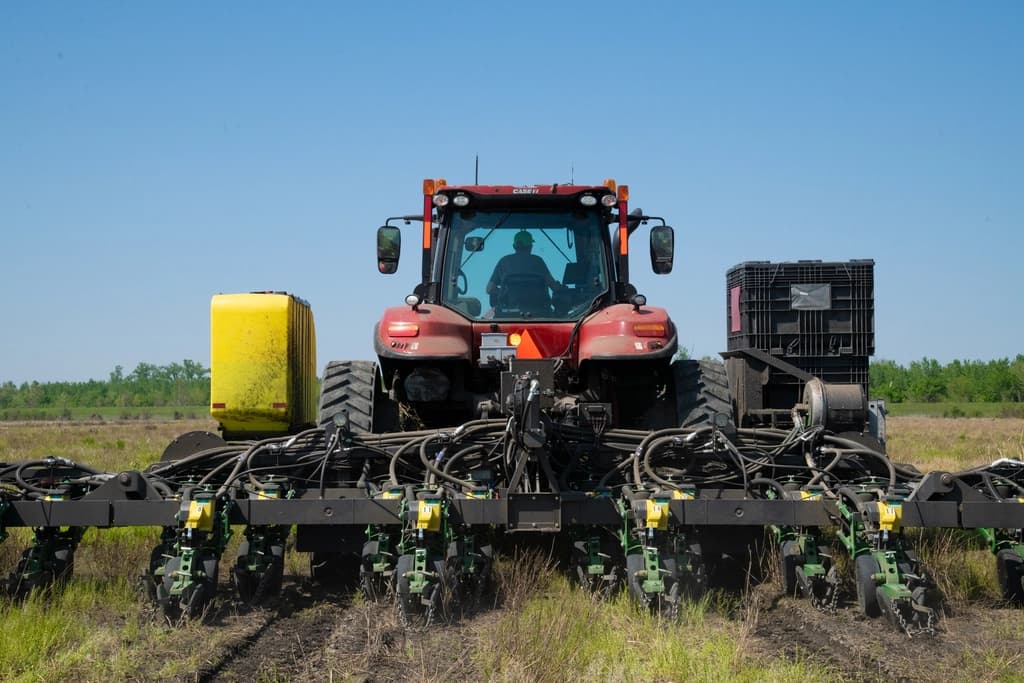 Tractor planting soybean seeds